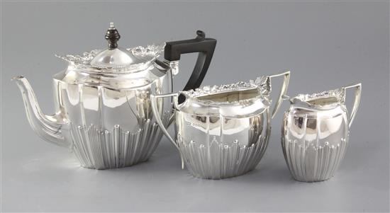 A late Victorian silver three piece tea set by James Dixon & Sons, gross 34.4 oz.